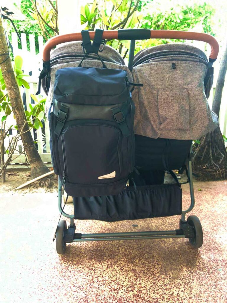 view of the back of the Zoe Twin Stroller with diaper bag hanging on it