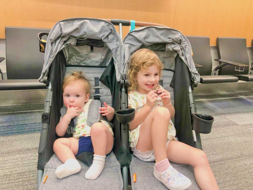 toddler and baby in Zoe Twin Double Stroller