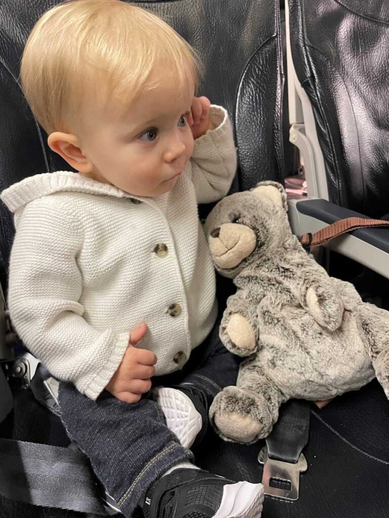 baby sitting on airplane seat