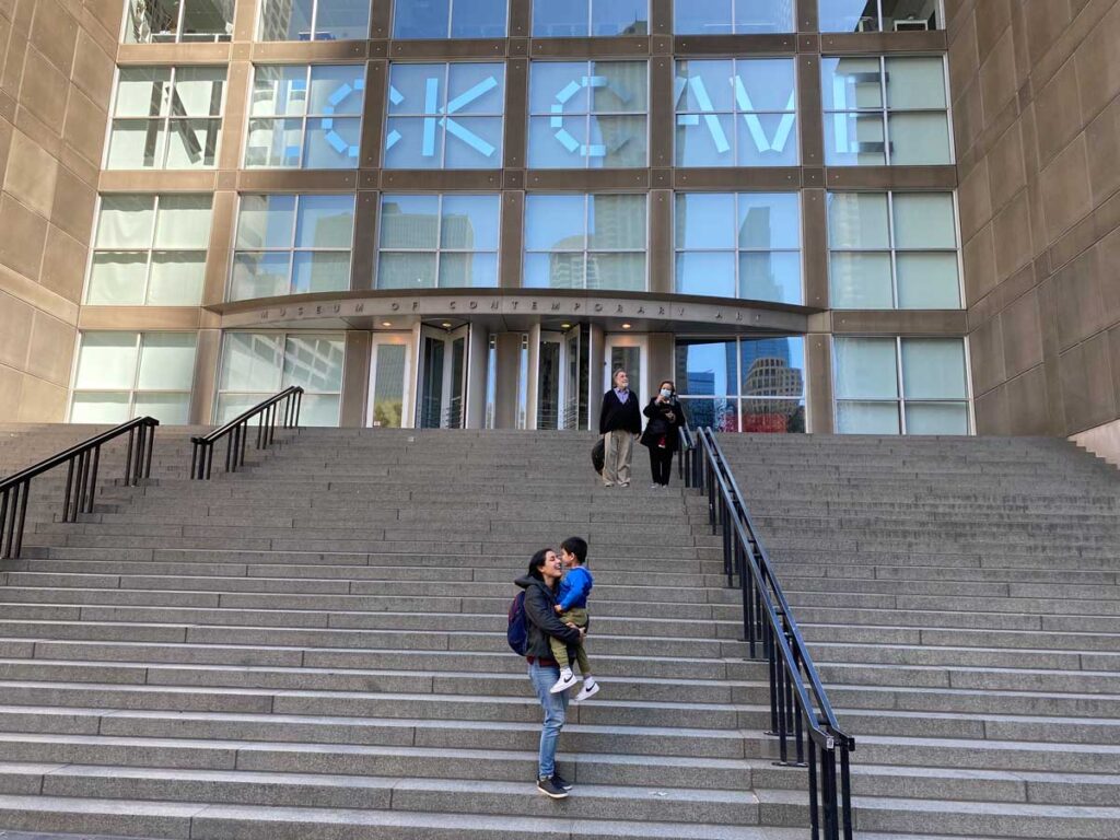 woman holding toddler on steps in Chicago