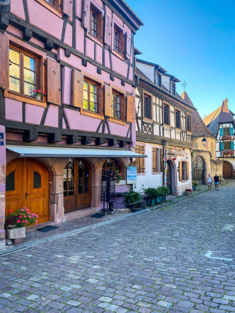 Colorful houses along street in Kaysersberg in Alsace region of France.