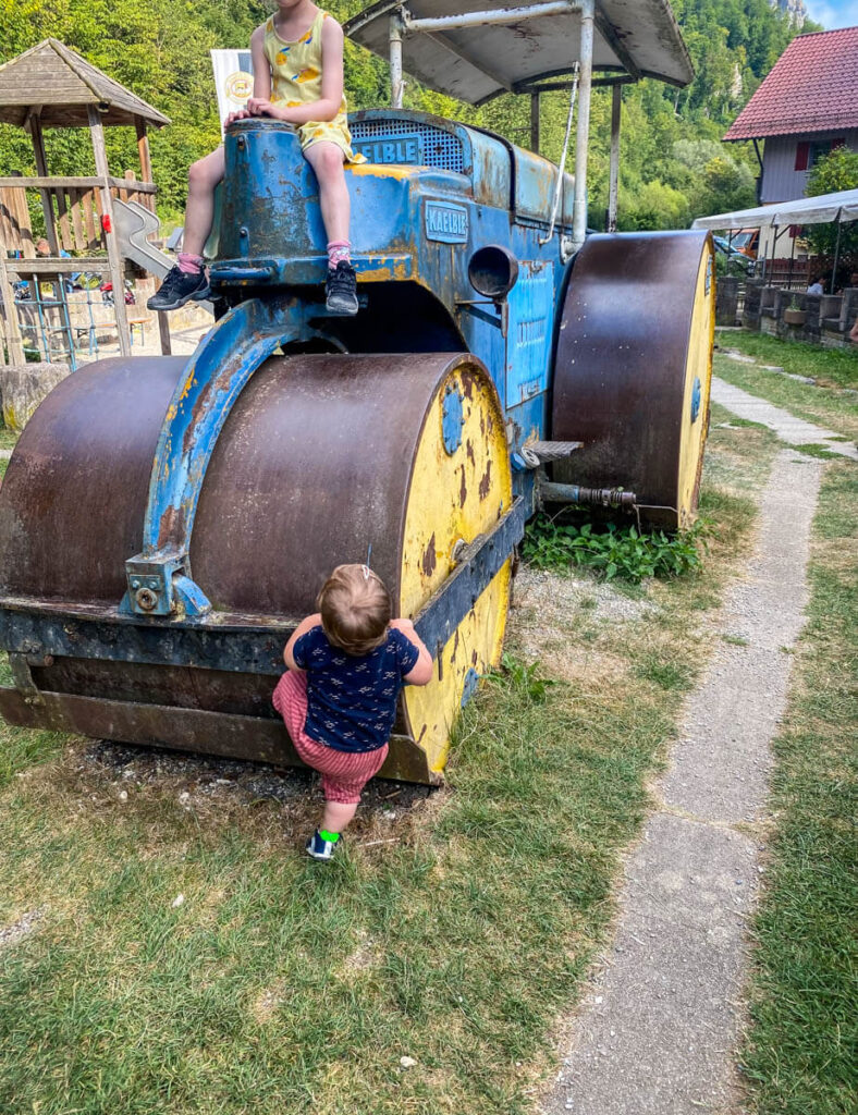 toddler playing near tractor at Obere Roggenmuhle playground - while visiting Germany with toddler.