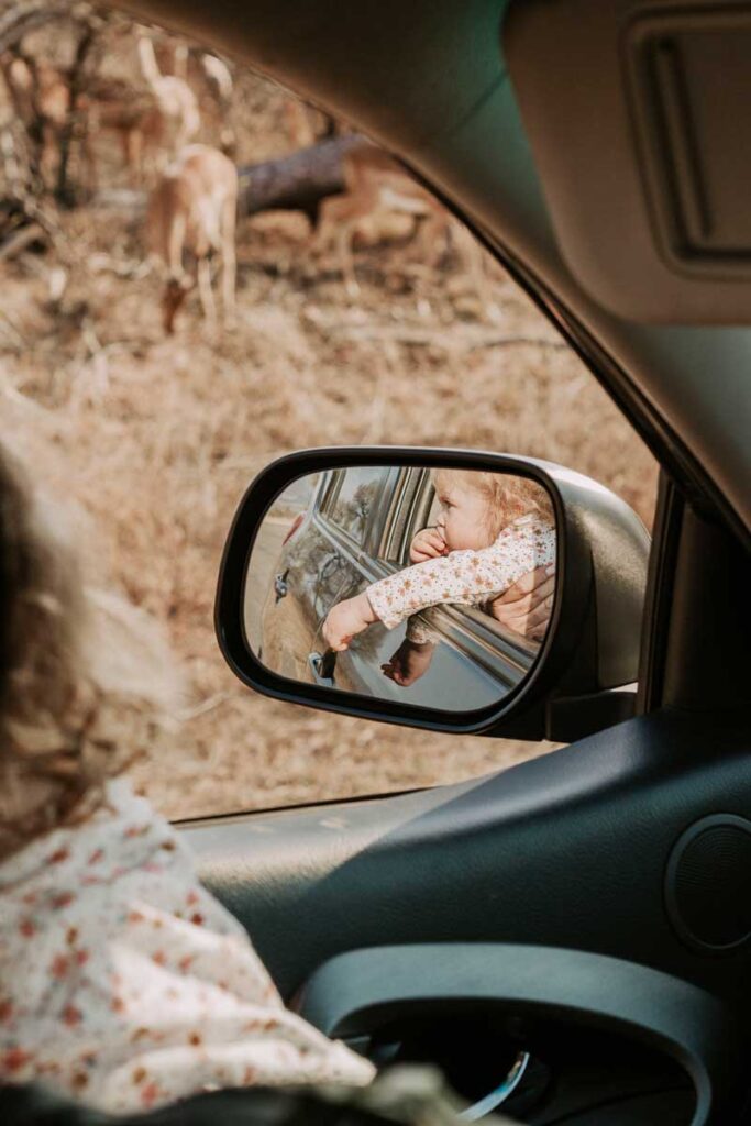 baby in rear view mirror of car on self-drive safari in Kruger