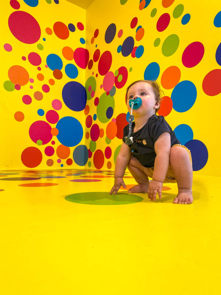 A 1 year old baby at the Triberg Fantasy Museum on a European family road trip vacation.