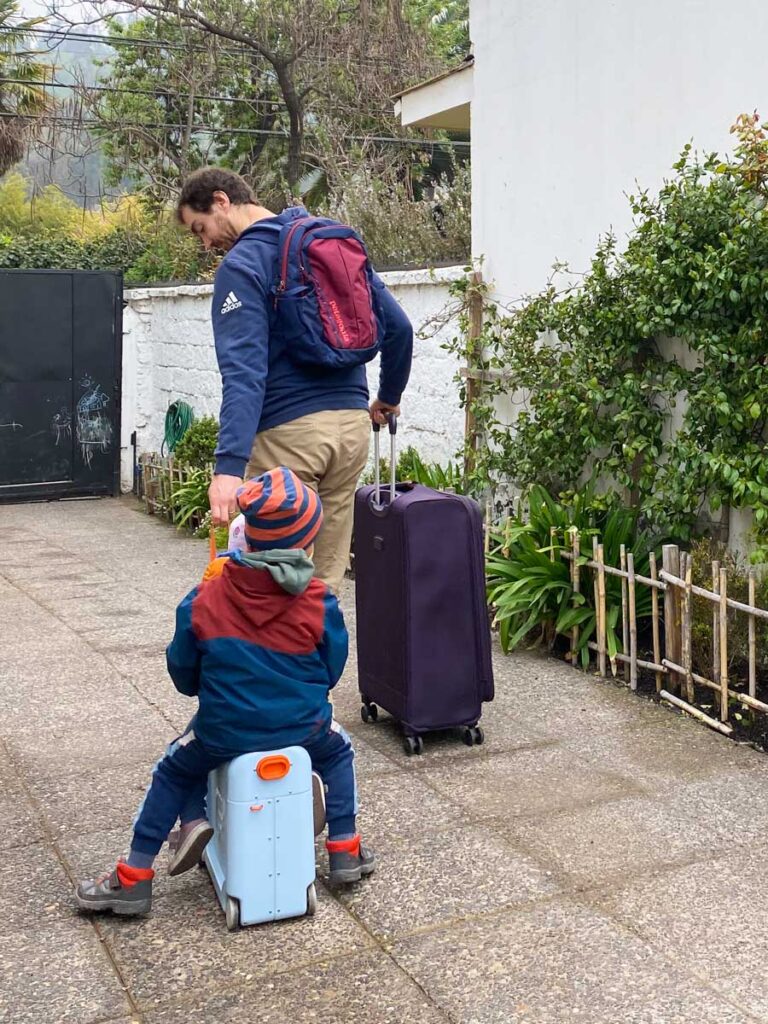 man pulling child on Stokke Jetkids BedBox ride-on suitcase