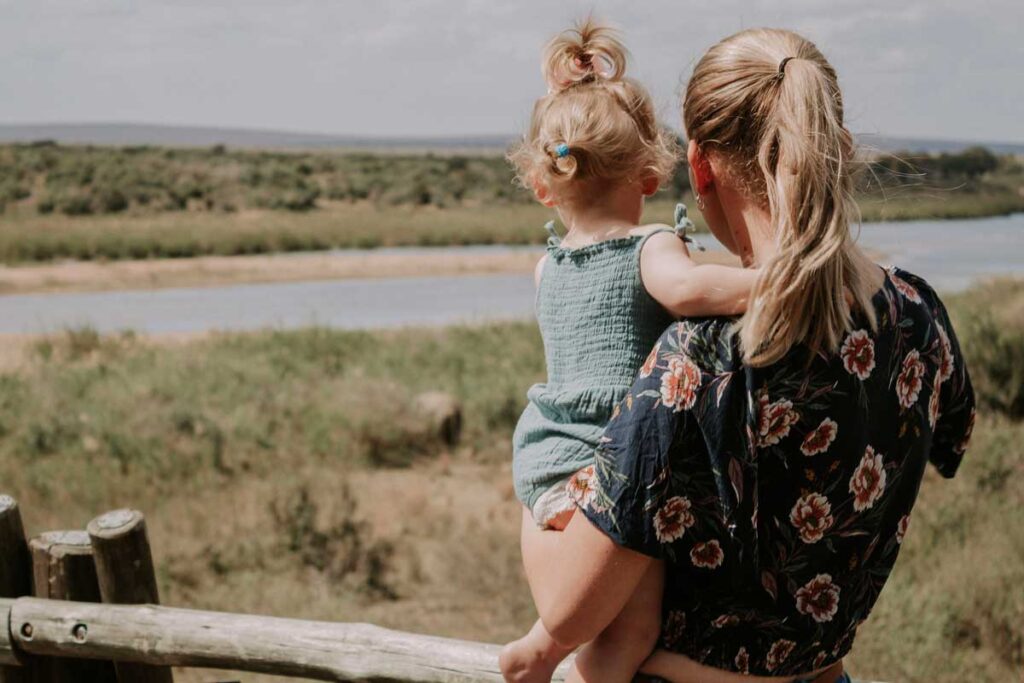 mother holding toddler on safari in Kruger National Park