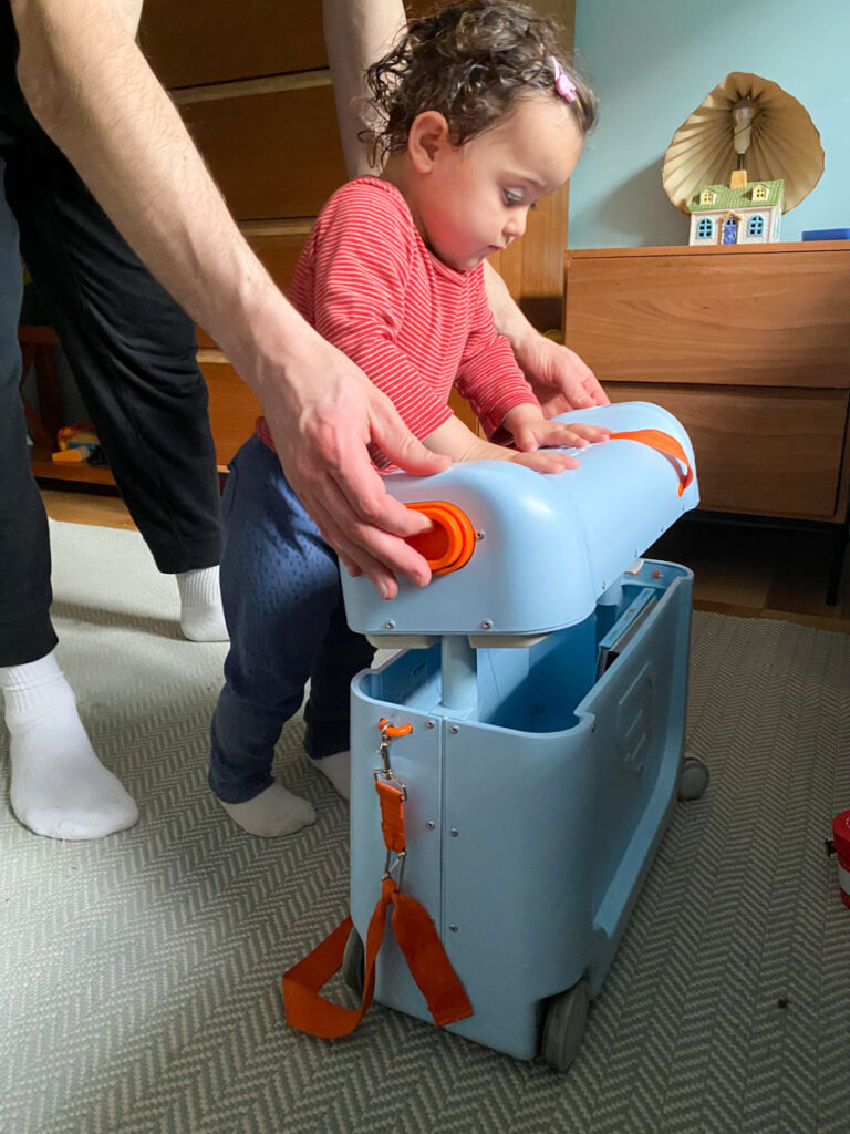 toddler getting help putting lid on JetKids BedBox