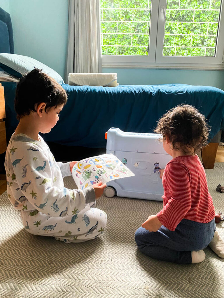 toddlers putting stickers on stokke jetkids bedbox