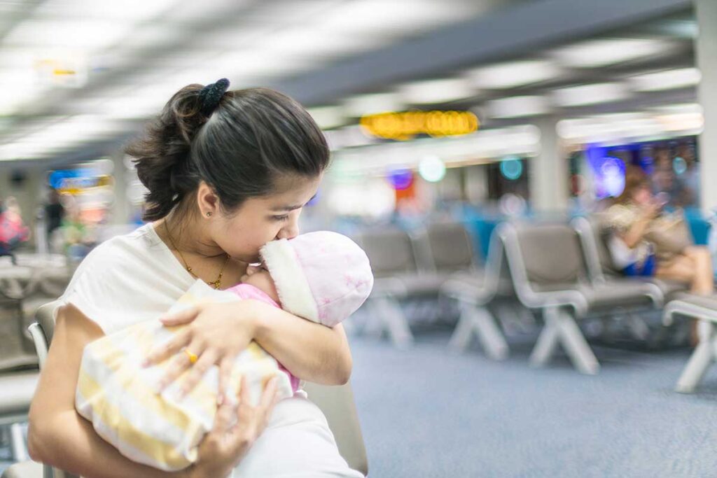 Mother holding baby in airport