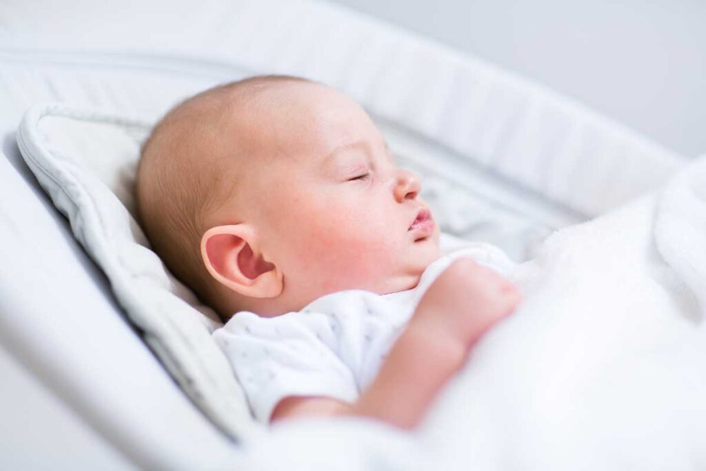 sleeping baby in travel baby bouncer