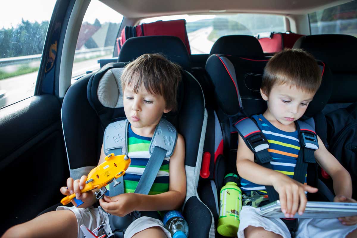 toddlers in car playing with toys in car seats