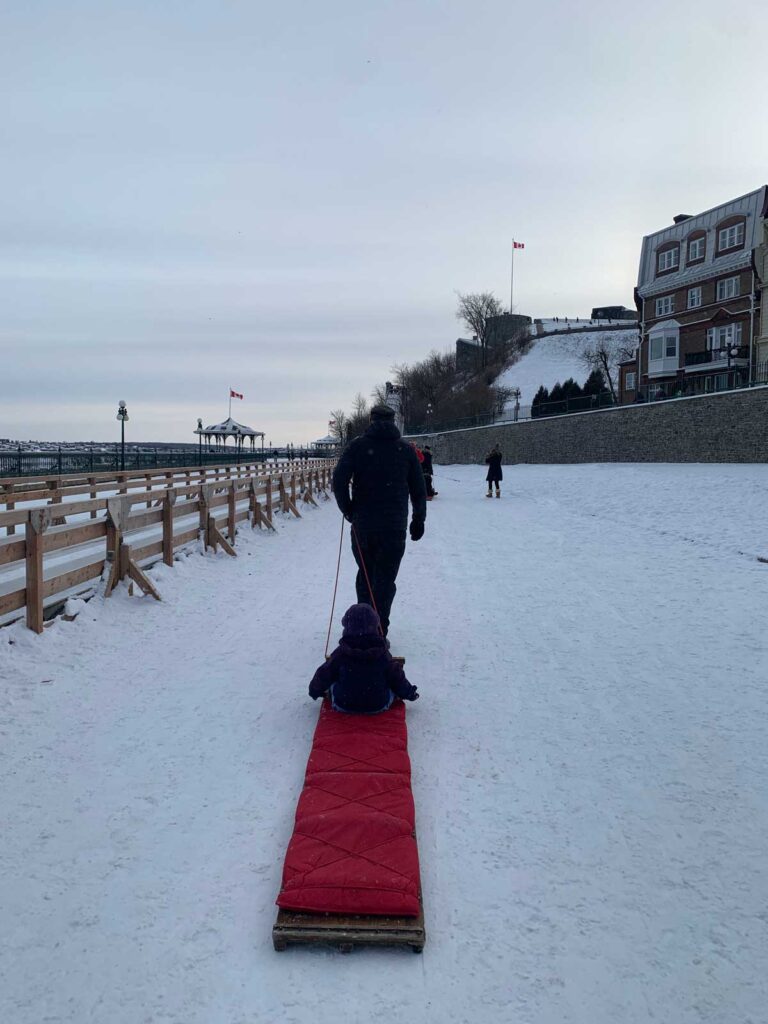 walking up 1884 toboggan in Quebec City in winter with a toddler