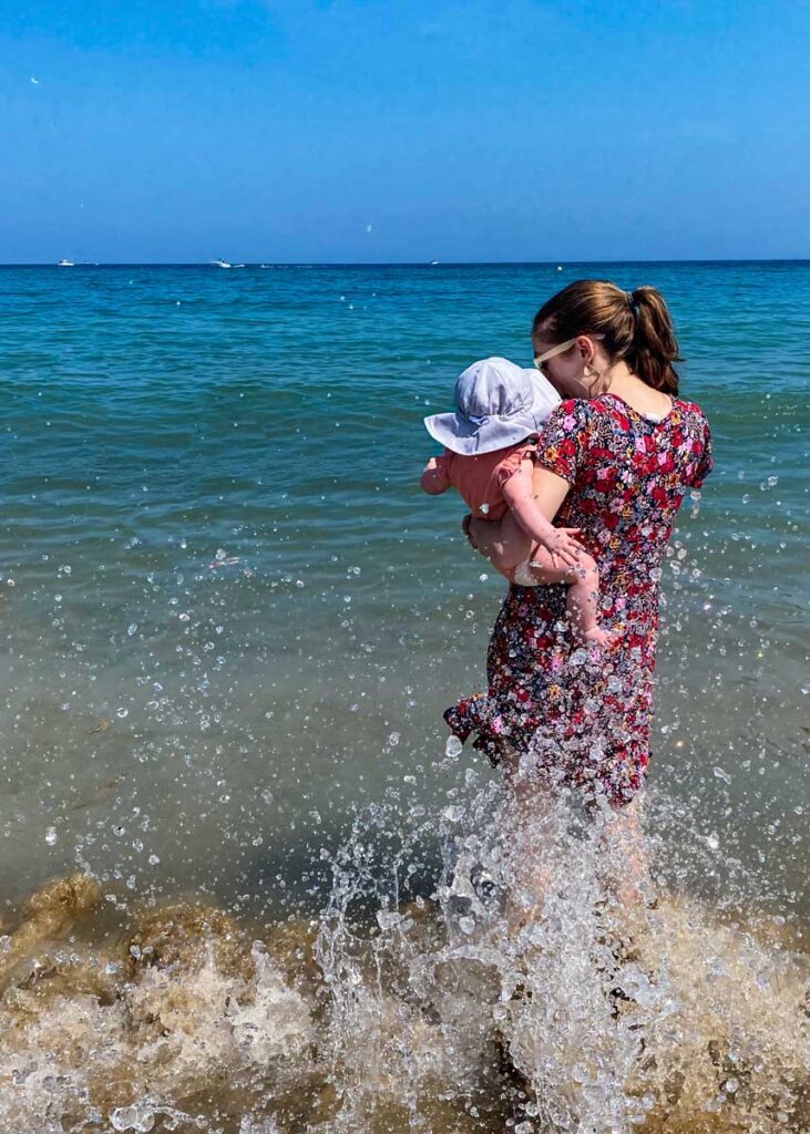 Mother holding baby at Barceloneta Beach - Barcelona with a Baby