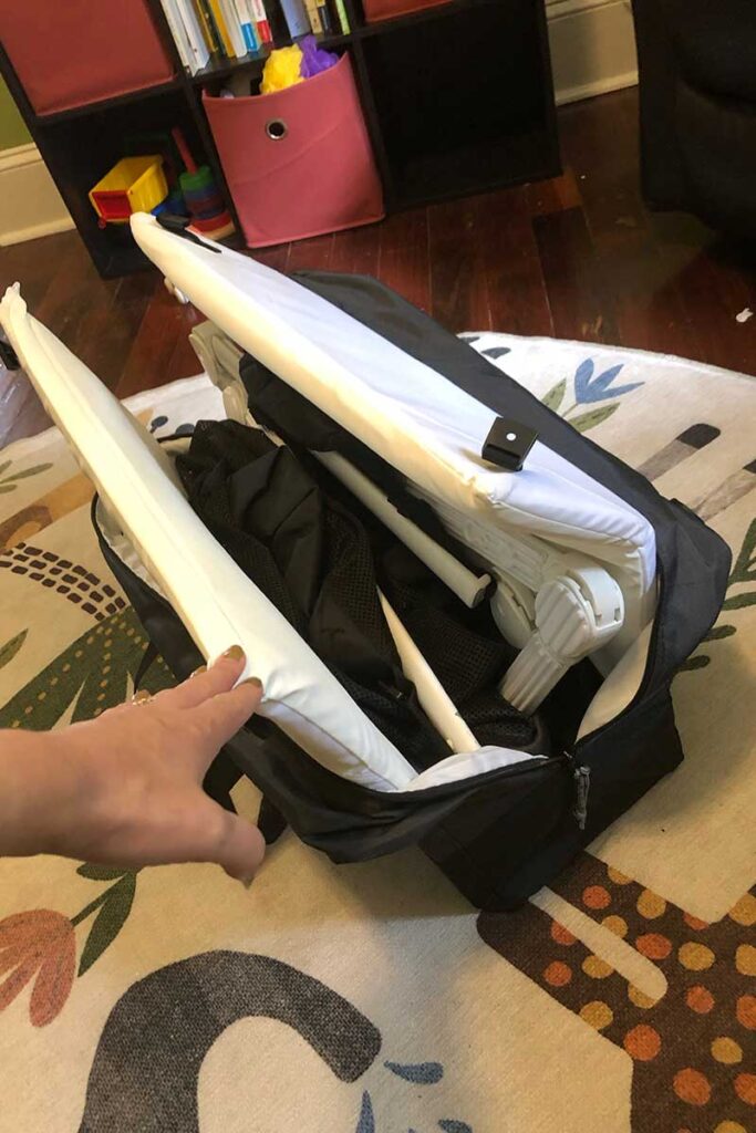 Guava Lotus Travel Crib packed up in the backpack