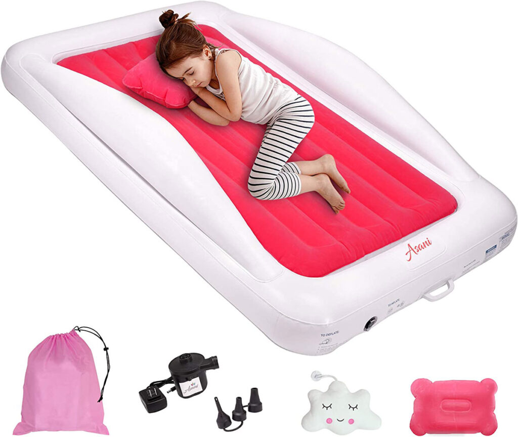 a child sleeps on an Asani toddler travel bed with bumpers.