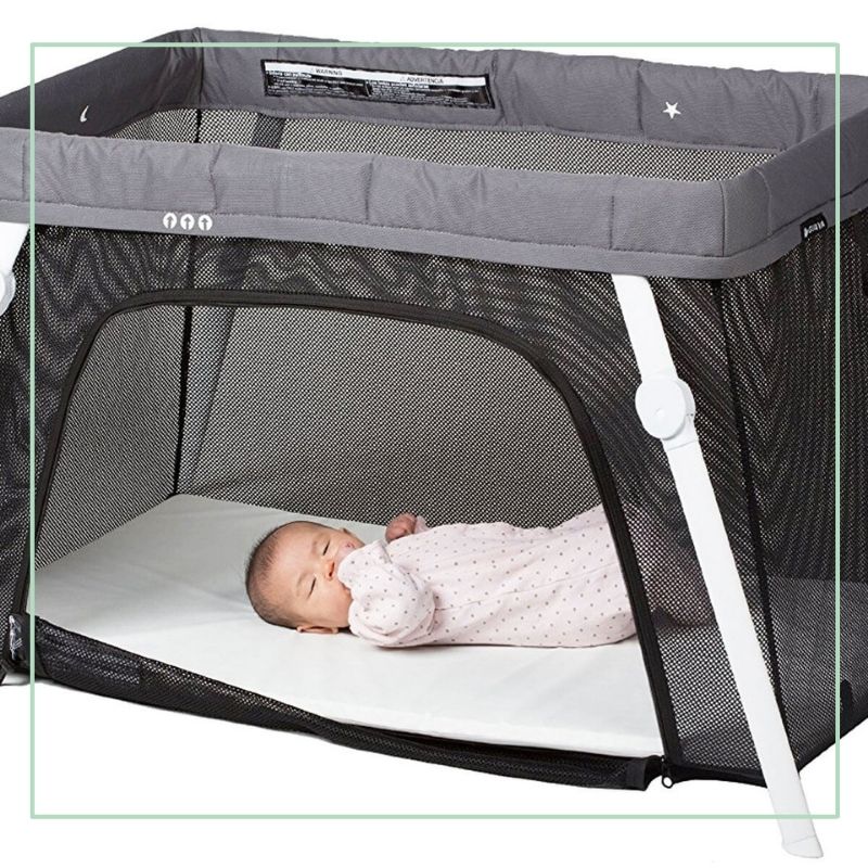 baby asleep in baby travel crib