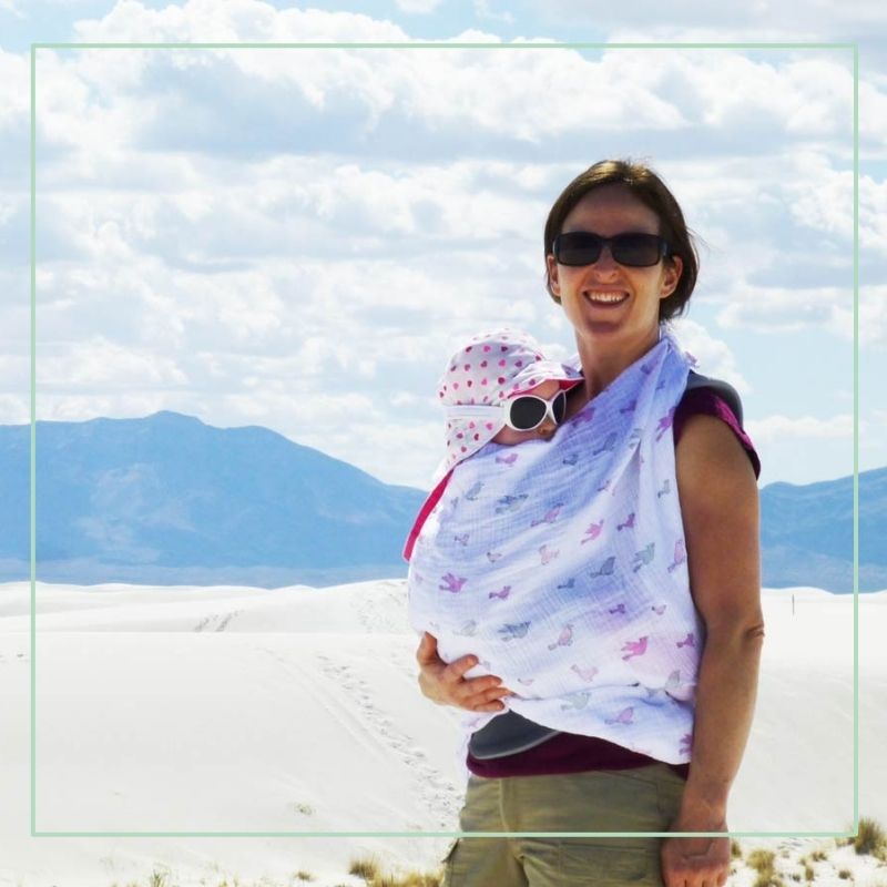 mother holding baby wrapped in blanket