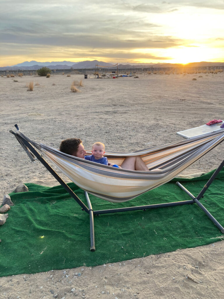 father holding baby in hammock - Best places to stay in Joshua Tree with a Baby