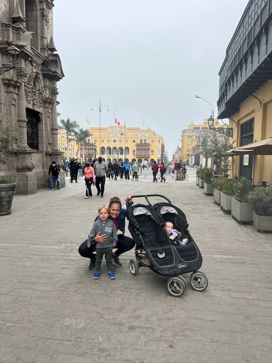 mother with double travel stroller at El centro historico in Lima with toddlers