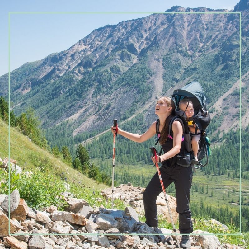 mother hiking with baby in backpack carrier