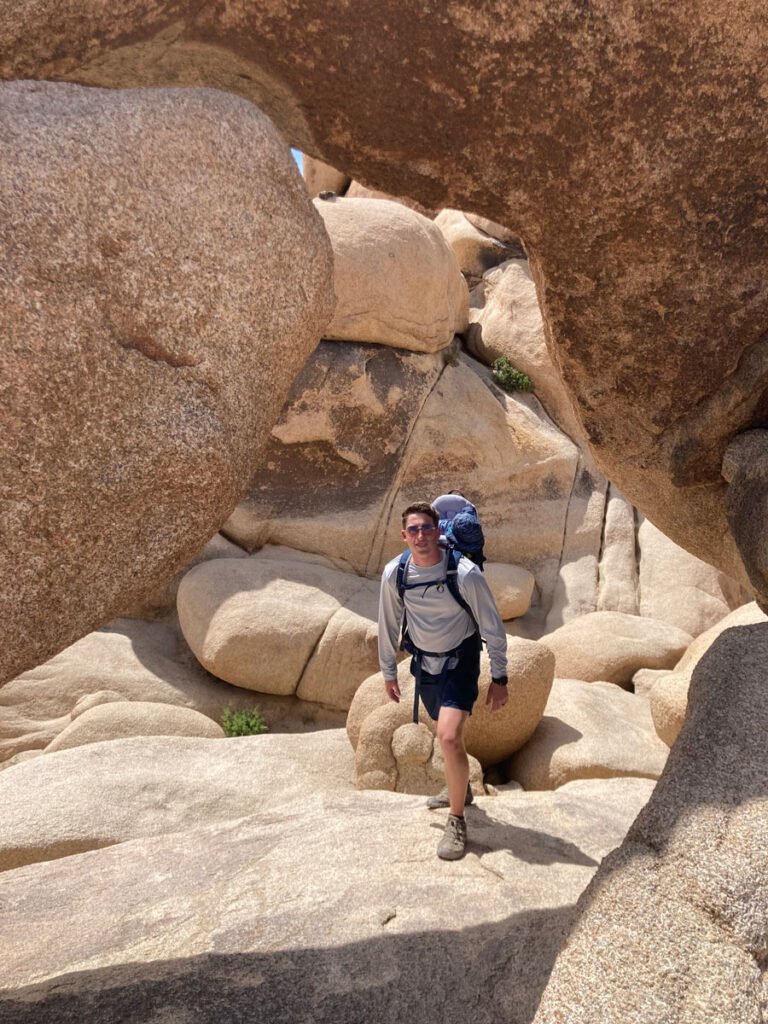 father with baby in backpack carrier Hiking Arch Rock - Joshua Tree with a Baby