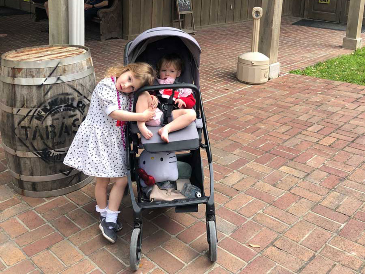 one girl standing next to toddler in Inglesina Electa Stroller