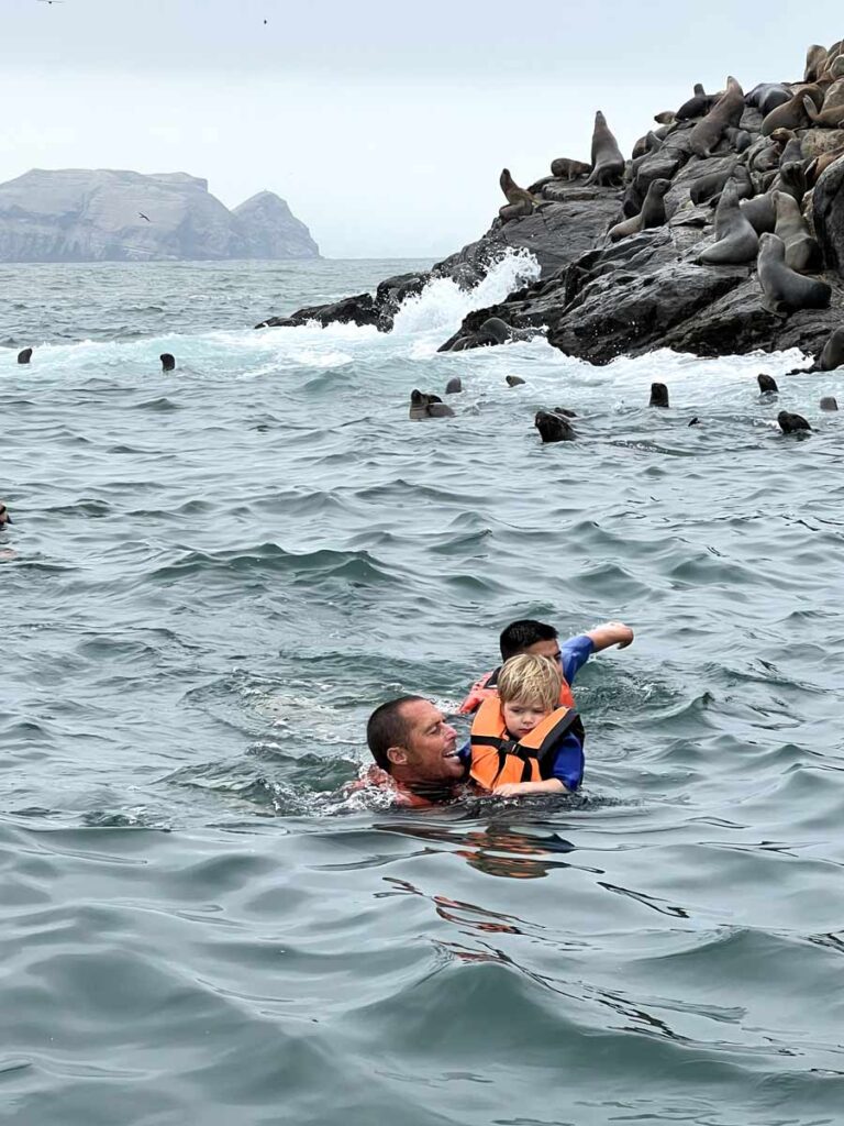 father in water with toddler on Mar Adentro Tour (visiting Peru with Toddlers)