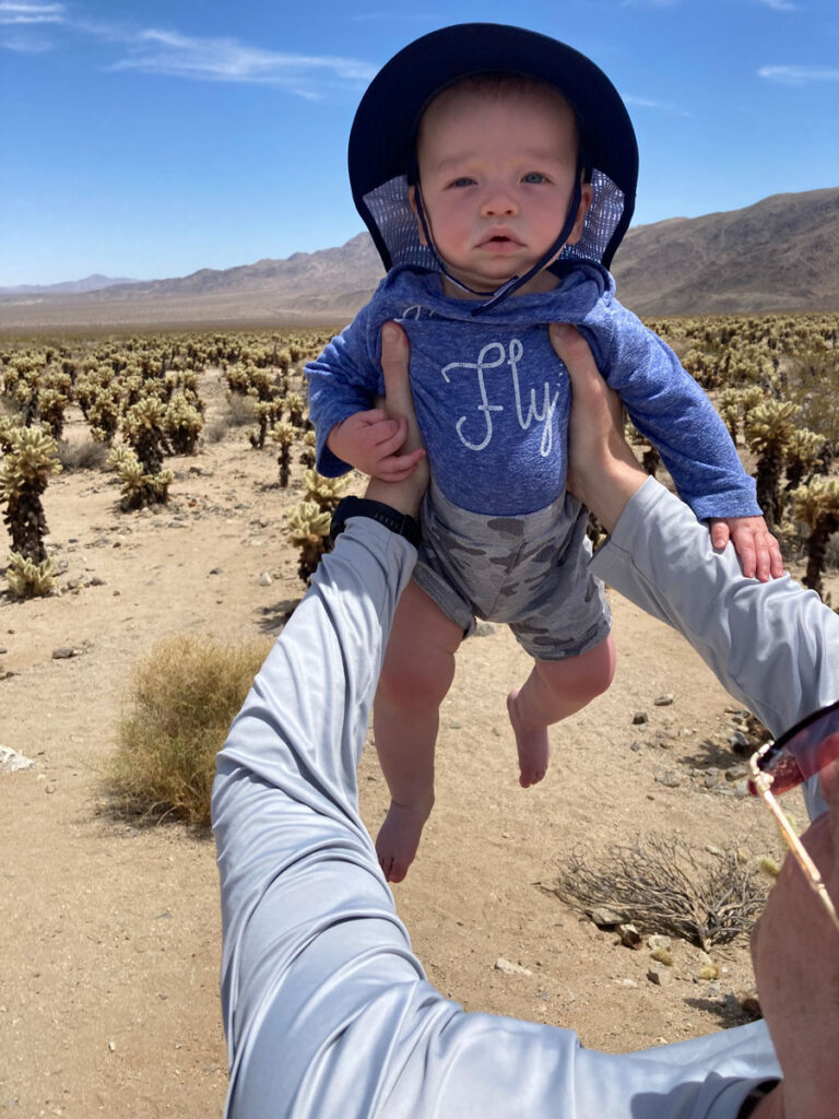 holding baby in sun hat up - Packing for Joshua Tree National Park with a Baby