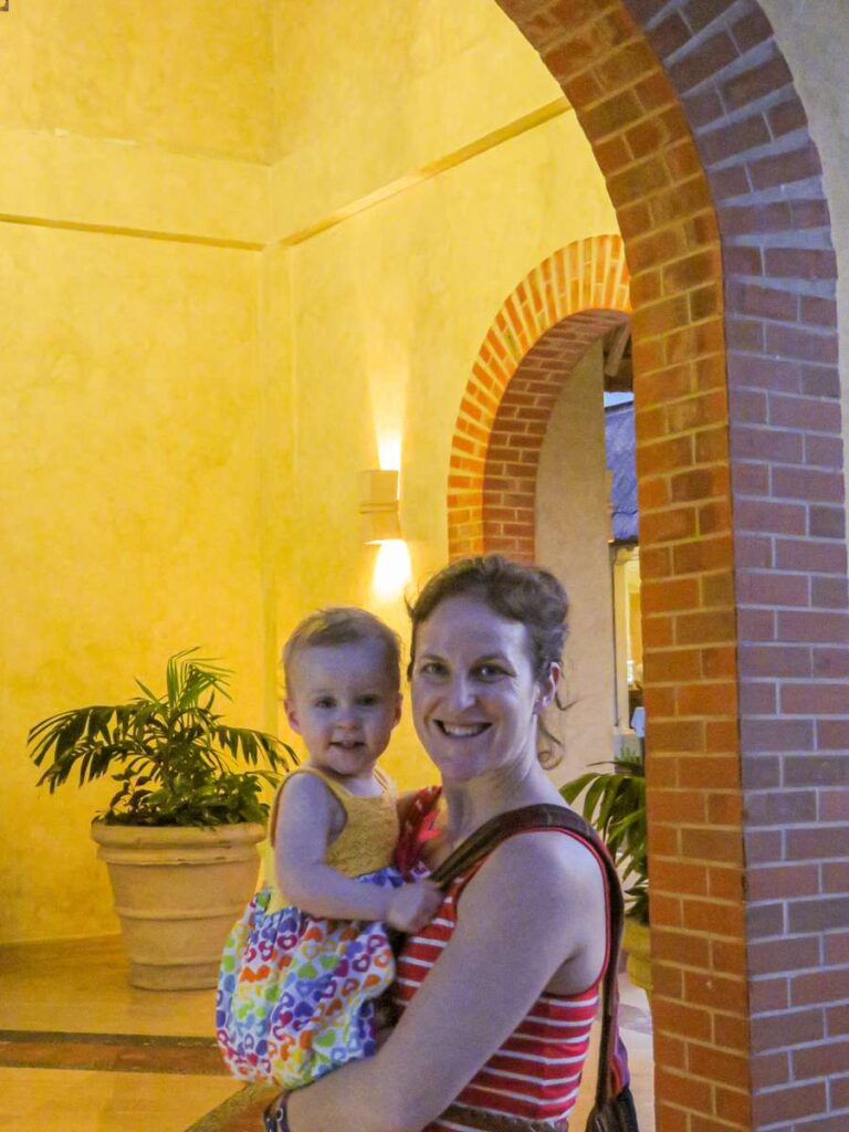 a mom and baby get ready for dinner at one of the best infant friendly resorts on our list.