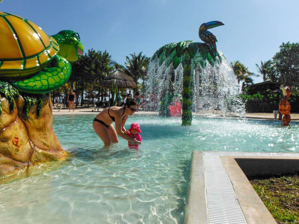 a mother plays in the kiddie pool at the Grand Palladium Kantenah - one of the best baby-friendly all-inclusive resorts in the Caribbean.