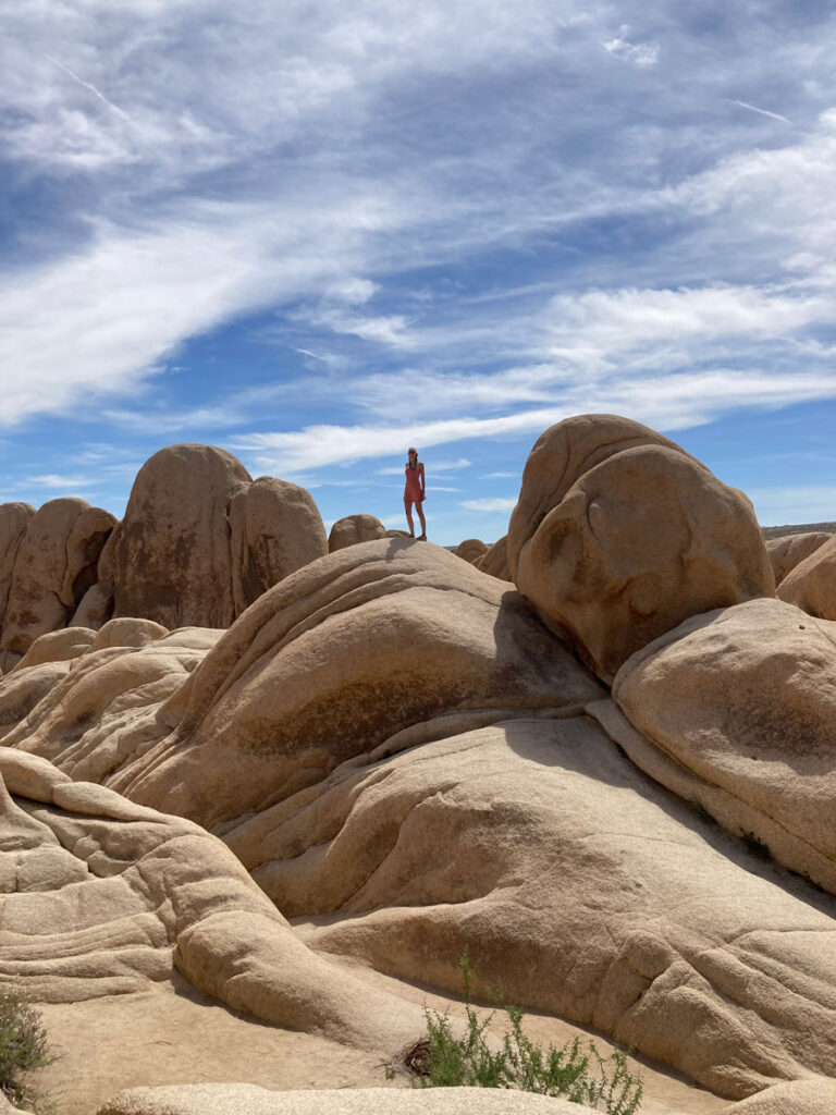 woman on rock formations - best things to do in Joshua Tree National Park