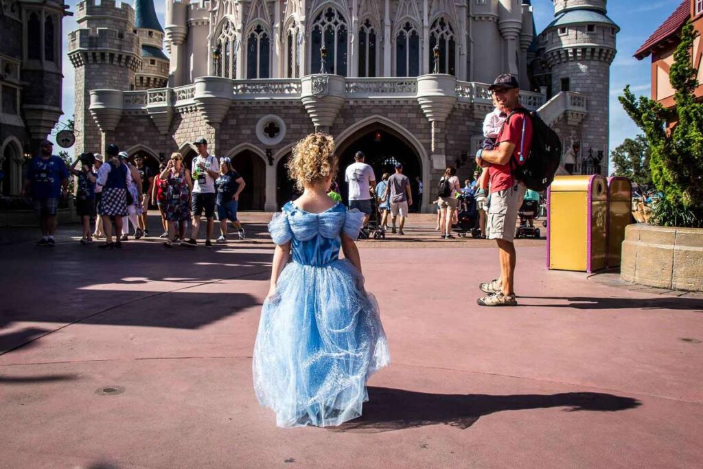 a young girl visiting Disney World with her family is all dressed up in a princess dress on her way to have breakfast with Cinderella