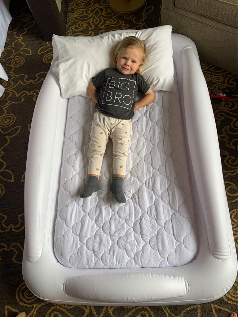 toddler on hiccapop inflatable travel bed.