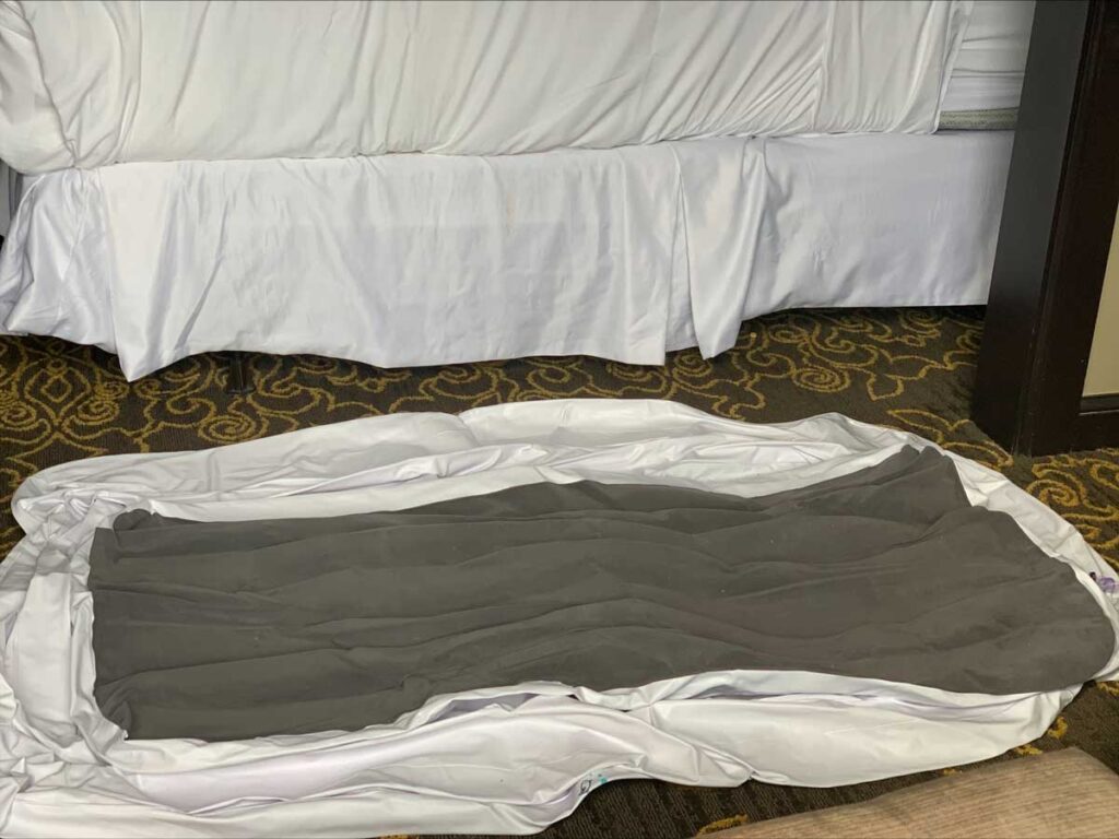 hiccapop inflatable mattress deflated on a hotel room