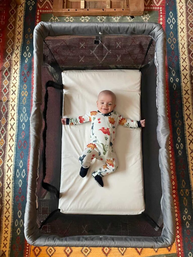 baby laying down in lotus everywhere travel crib