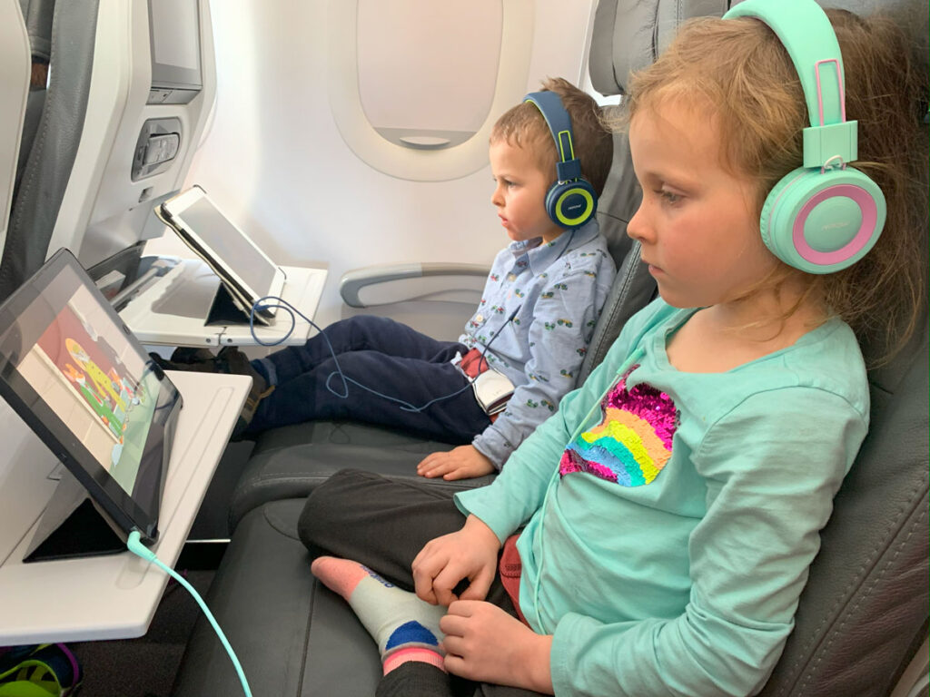 two siblings wear identical headphones for toddlers - conveniently purchased as a 2-pack of toddler headphones.