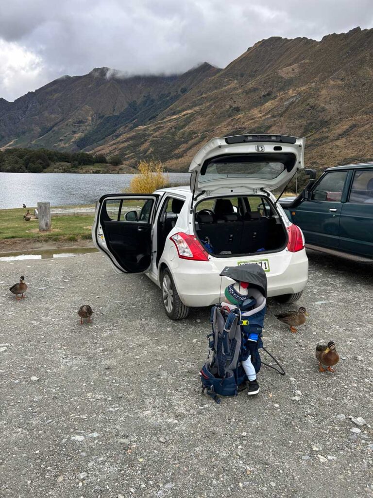 Deuter Kid Comfort Active Carrier sitting on ground outside of car.