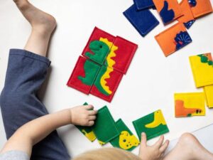 a dinosaur puzzle made from soft felt is a fun screen free travel toy.