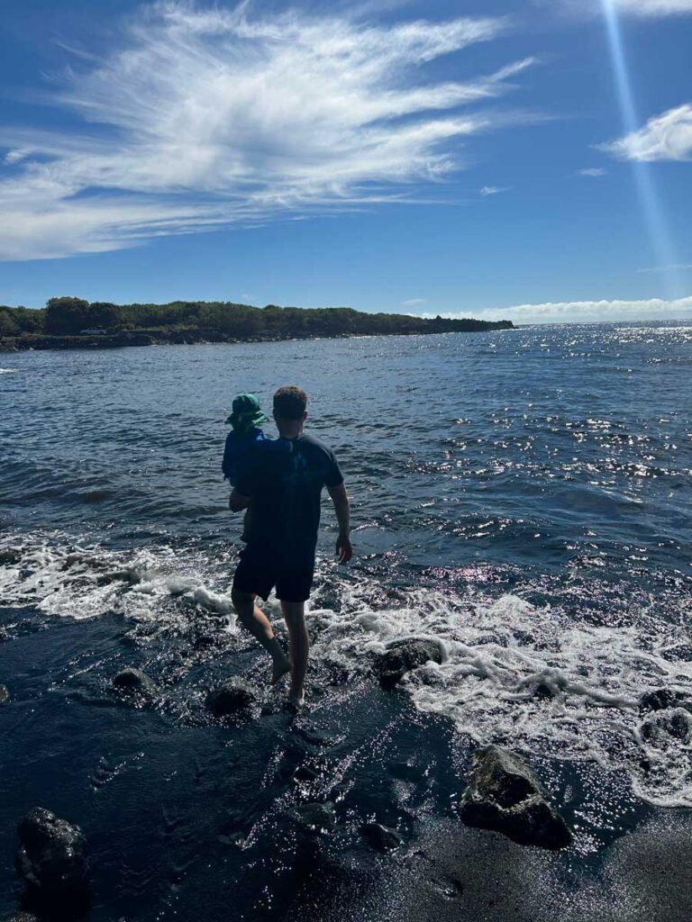 father holding toddler at Black Sands Beach - Hawaii