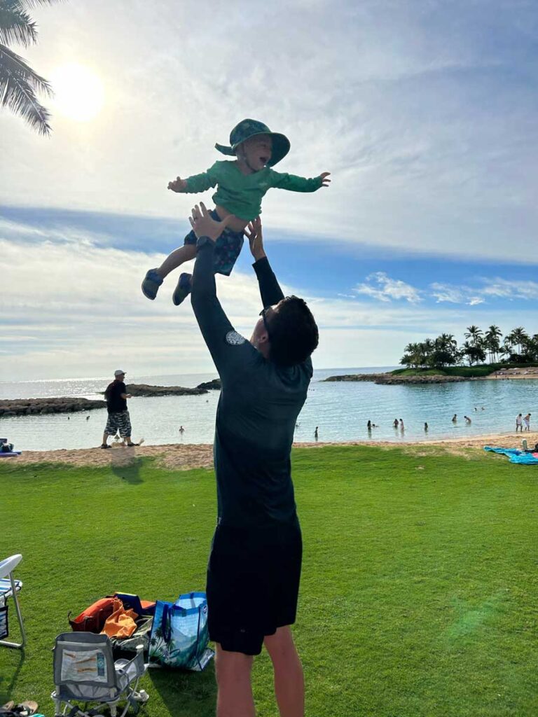 father tossing toddler in air - Hawaii family vacation