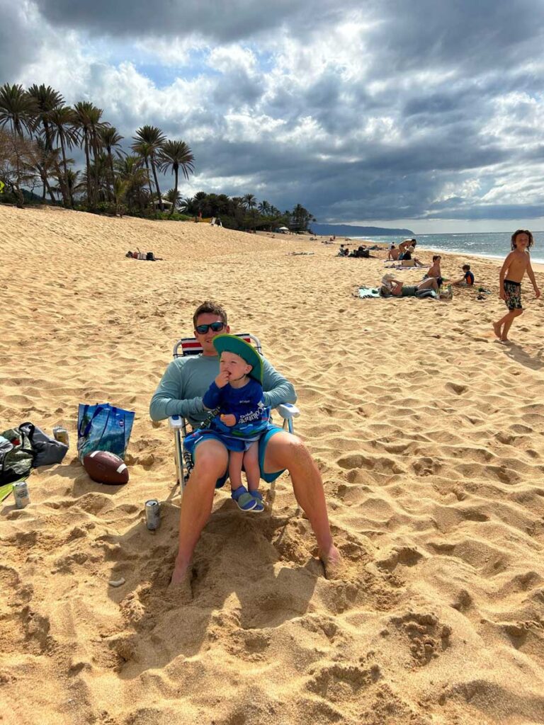 father with toddler on hawaii beach