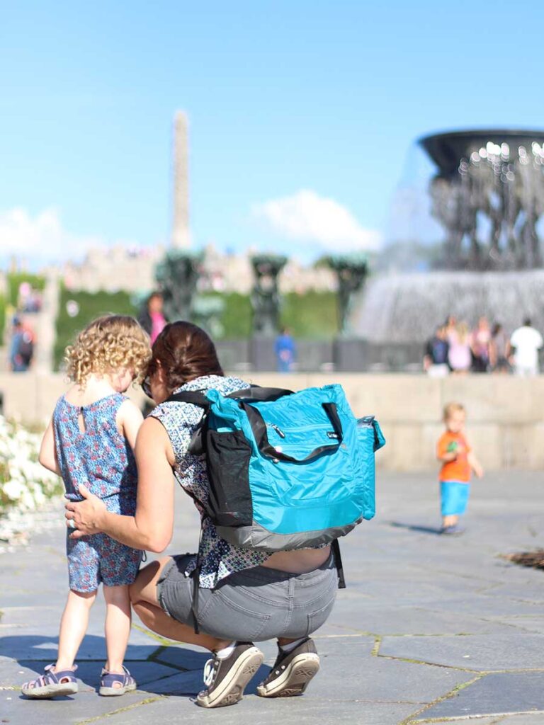 Celine Brewer, from the baby travel blog Baby Can Travel, wears a diaper backpack on a family trip to Norway.