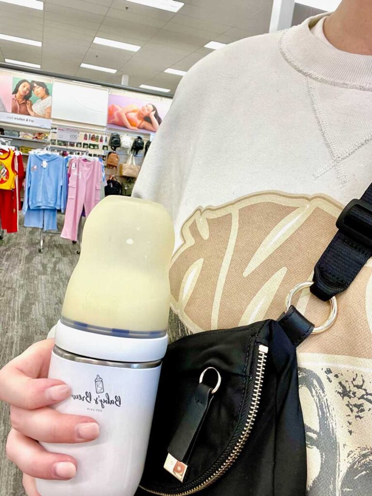 mother carrying Baby's Brew Portable Bottle Warmer