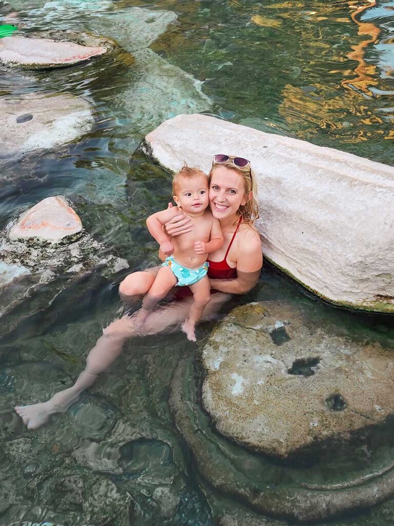 mother holding baby Cleopatras Pool - turkey with a baby