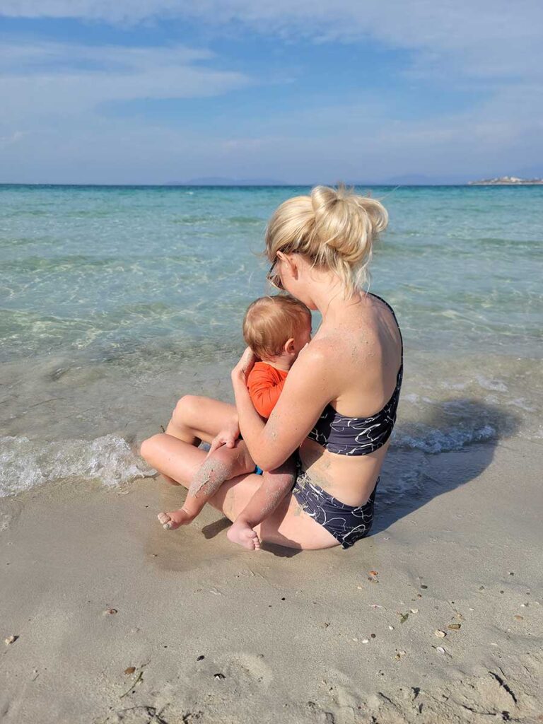 mother holding baby on Cesme Beach