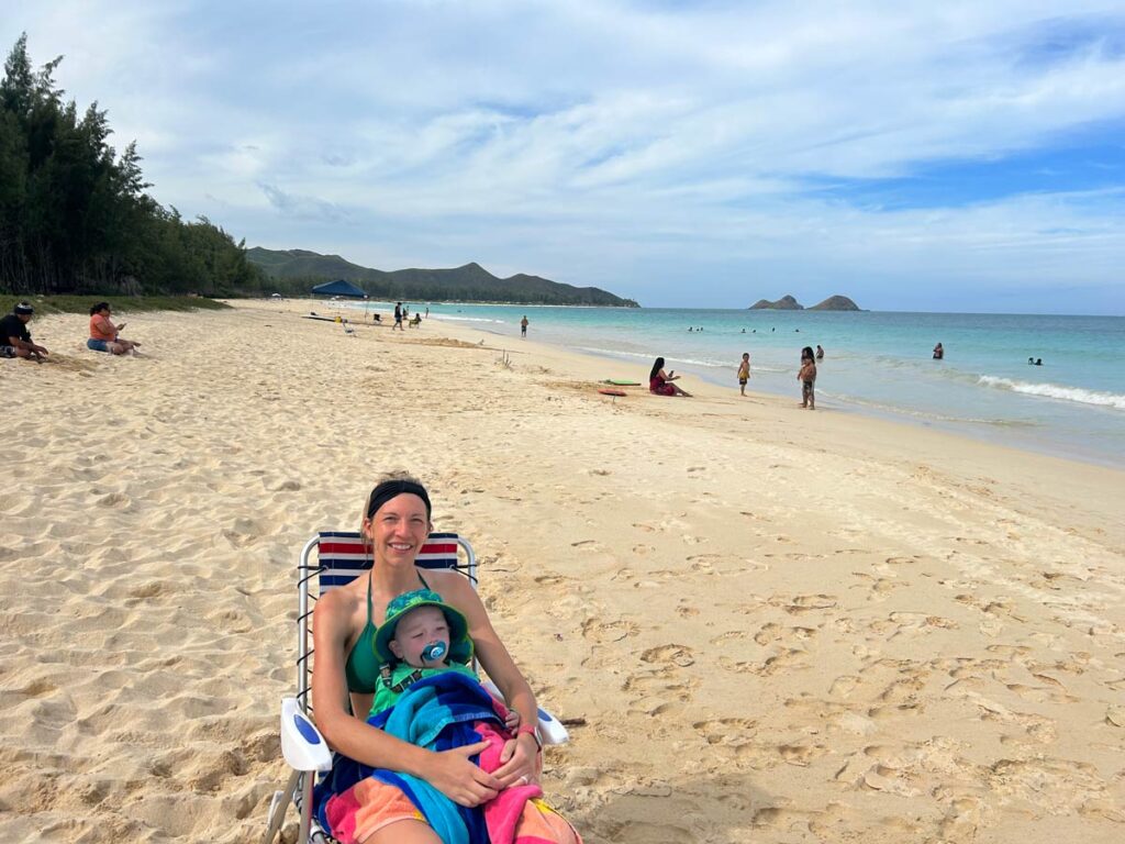 mother holding toddler on beach - Hawaii