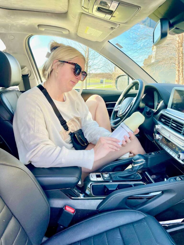 mother using Baby's Brew Bottle warmer in car