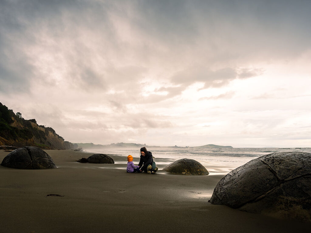 playing with toddler at Moeraki Boulders Beach