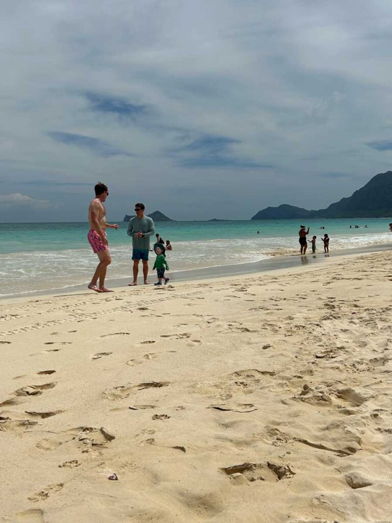 playing with toddler on beach in Hawaii