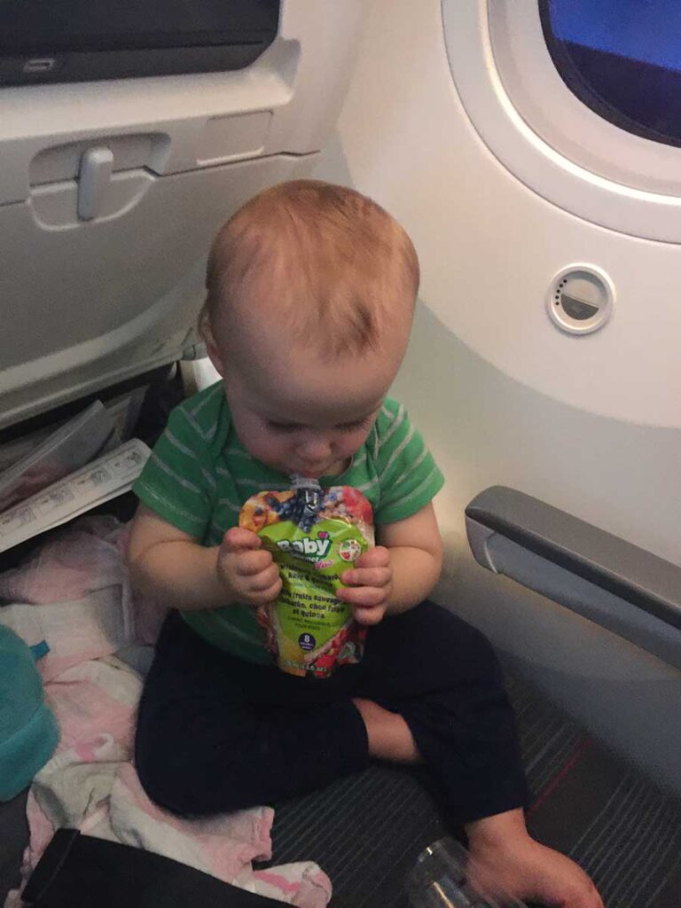 1 year old having a snack while flying.